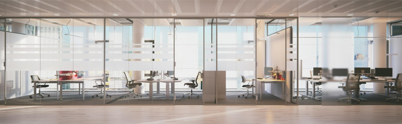 Row of glass cubicles in a large commercial office