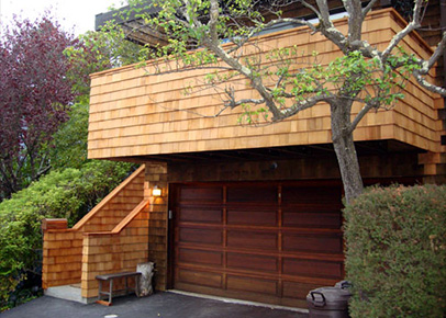 A deck above the garage of a residential house.