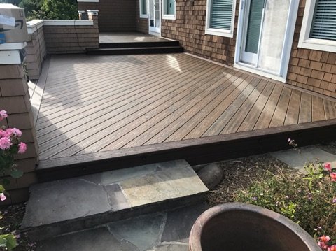 A multi-level deck built onto a residential house.